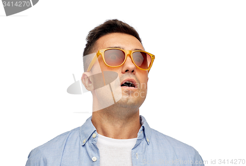 Image of face of scared man in shirt and sunglasses