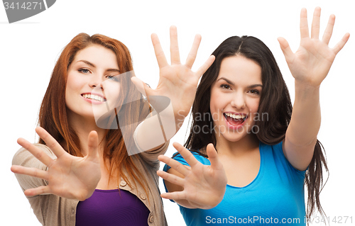 Image of two smiling girls showing their palms