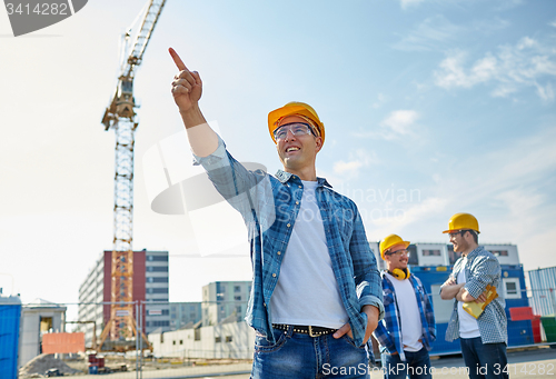 Image of builders pointing finger aside on construction