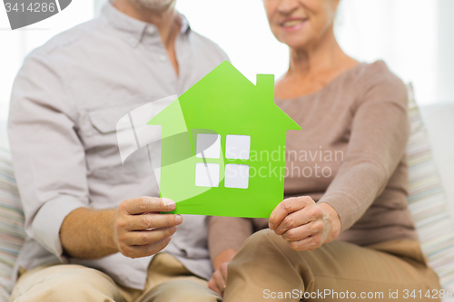 Image of close up of happy senior couple with green house