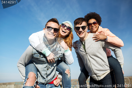 Image of happy friends in shades having fun outdoors