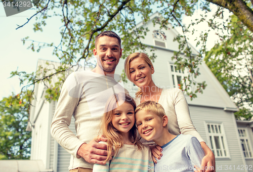 Image of happy family in front of house outdoors