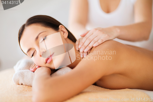 Image of beautiful woman in spa having massage