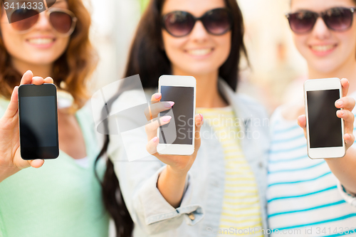 Image of close up of happy young women with smartphone