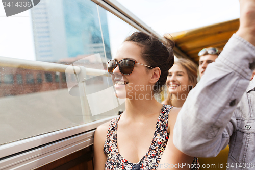 Image of teenage girl with friends traveling by tour bus
