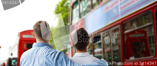 Image of close up of gay couple hugging over london city