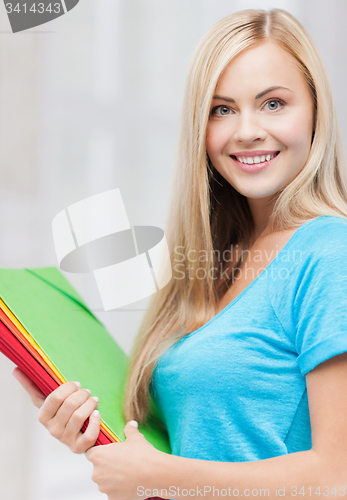 Image of smiling student with folders