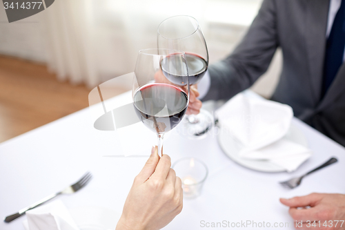 Image of young couple with glasses of wine at restaurant