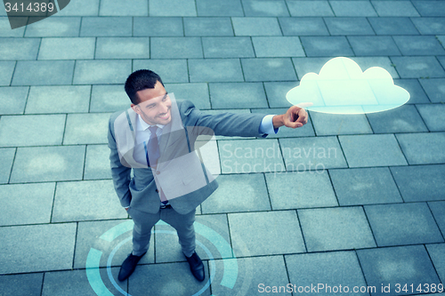 Image of smiling businessman with cloud projection outdoors