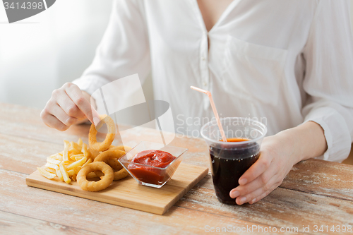 Image of close up of woman with snacks and cocacola