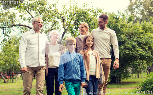 Image of happy family in front of house outdoors