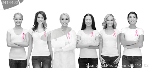 Image of smiling women with pink cancer awareness ribbons