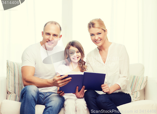 Image of smiling parents and little girl with at home