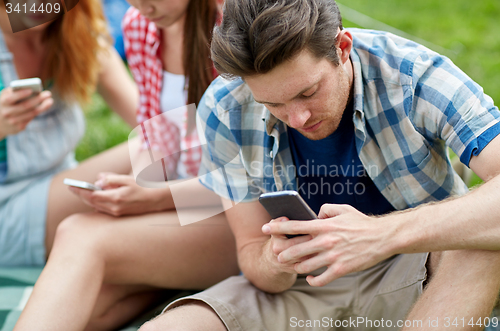 Image of friends with smartphone at camping