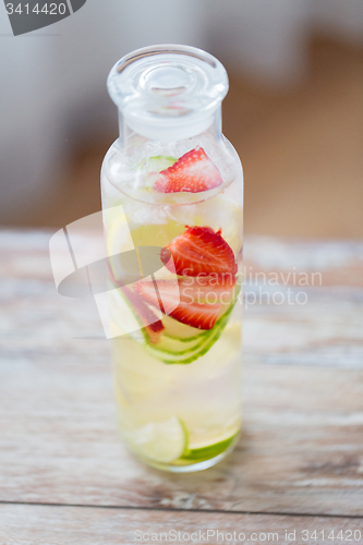 Image of close up of fruit water in glass bottle