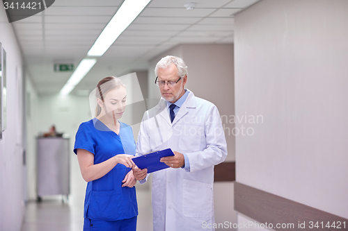 Image of senior doctor and nurse with tablet pc at hospital
