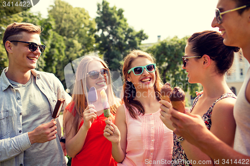 Image of group of smiling friends with ice cream outdoors