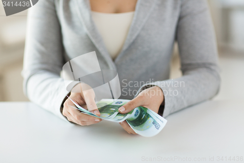 Image of close up of woman hands counting euro money