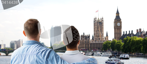 Image of close up of male gay couple hugging over big ben