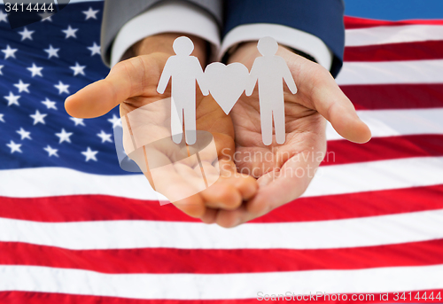 Image of close up of happy male gay couple with love symbol