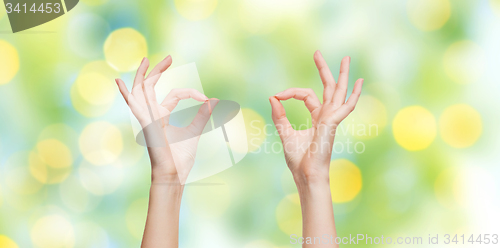 Image of woman hands showing ok sign over blue sky