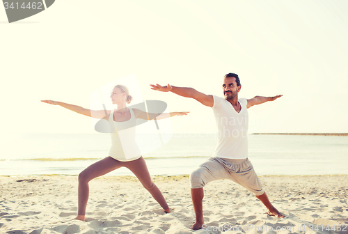 Image of couple making yoga exercises outdoors