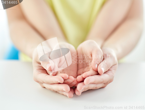 Image of close up of woman and girl with cupped hands