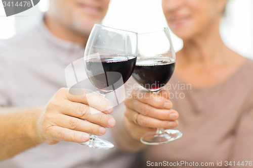 Image of close up of happy senior couple with red wine