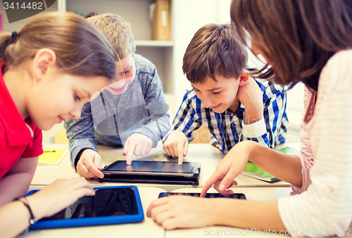 Image of group of school kids with tablet pc in classroom