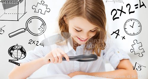 Image of girl reading book with magnifier at school