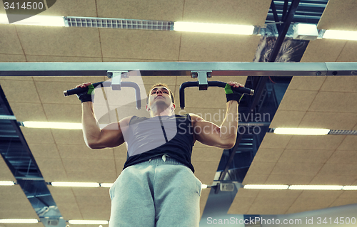 Image of young man exercising in gym