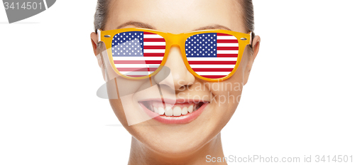 Image of happy teenage girl in glasses with american flag