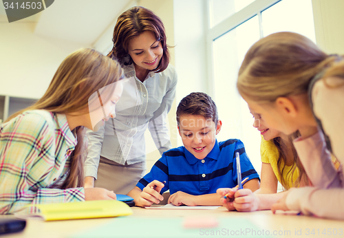 Image of group of school kids writing test in classroom