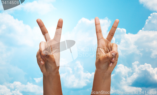 Image of two african hands showing victory or peace sign