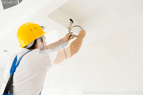 Image of close up of builder or electrician running wires