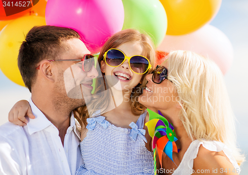 Image of family with colorful balloons