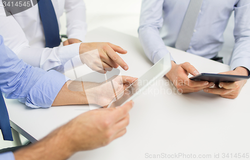Image of close up of businessman hands with tablet pc