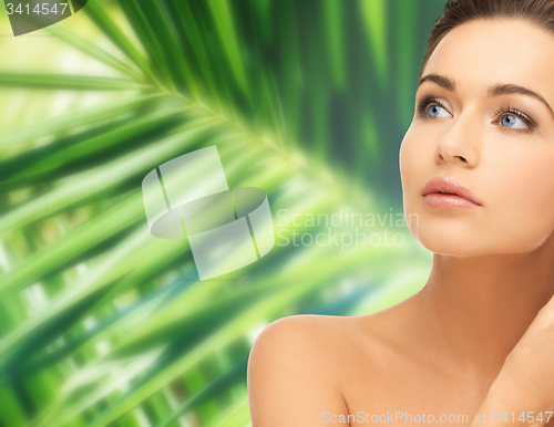 Image of woman touching her face skin