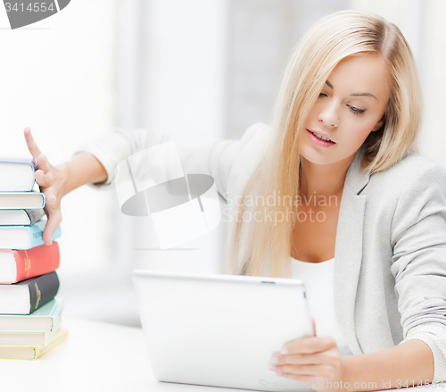 Image of student with books and tablet pc