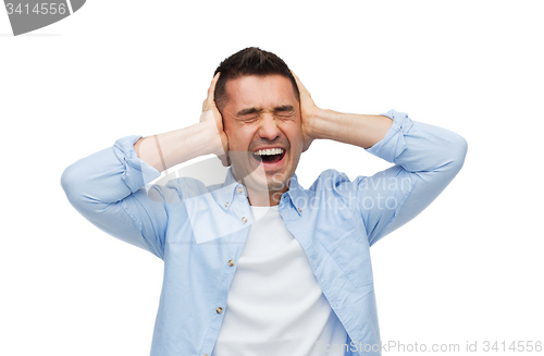 Image of unhappy man with closed eyes touching his forehead