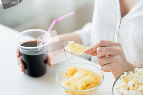 Image of close up of woman with junk food and coca cola cup