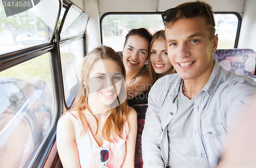 Image of happy teenage friends traveling by bus
