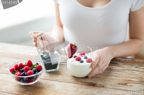 Image of close up of woman hands with yogurt and berries