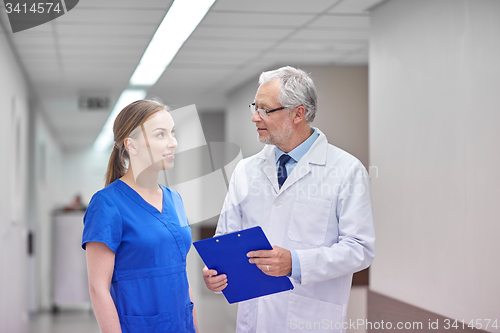 Image of senior doctor and nurse with tablet pc at hospital