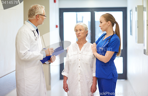 Image of medics and senior patient woman at hospital