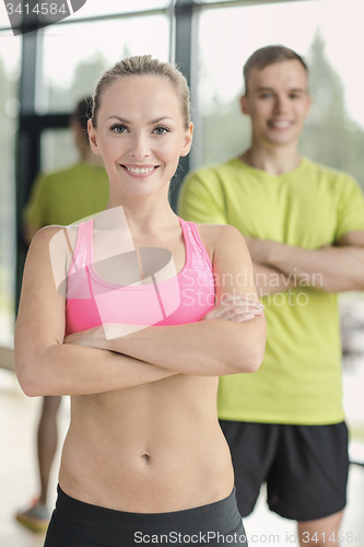 Image of smiling man and woman in gym