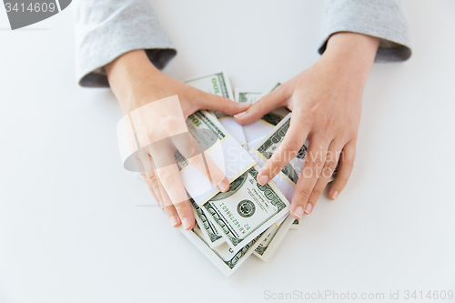 Image of close up of woman hands counting us dollar money