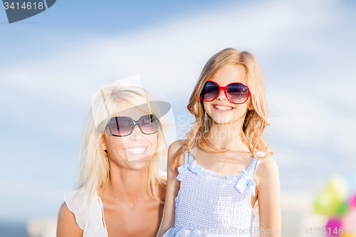 Image of mother and child in sunglasses