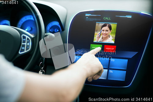 Image of male hand receiving video call on car panel screen