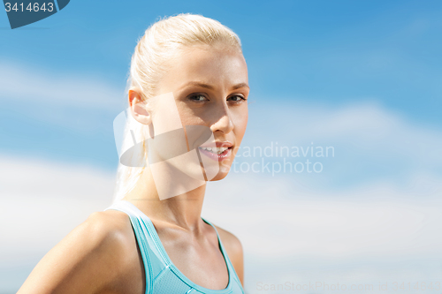 Image of happy young sporty woman outside